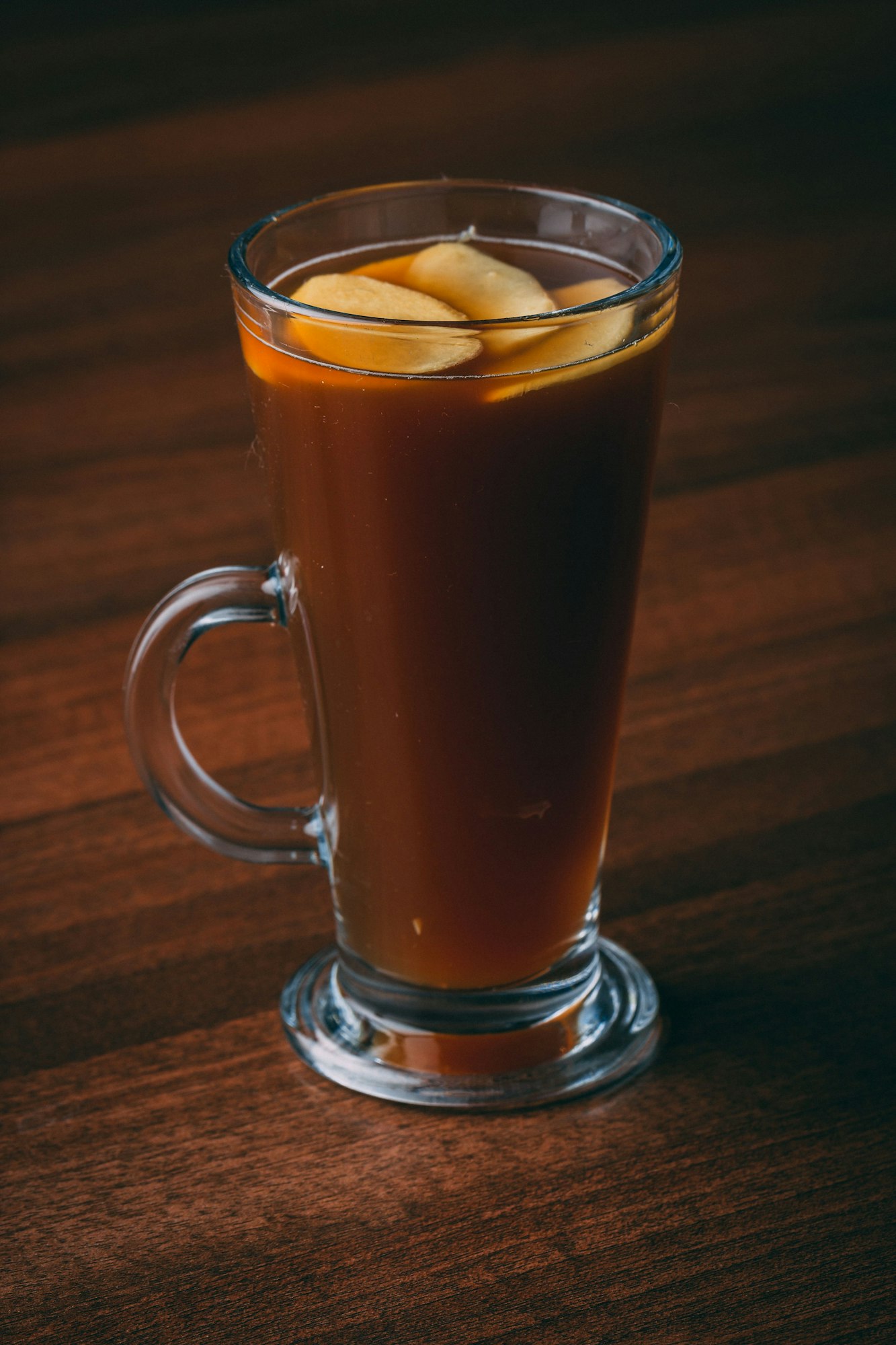 Vertical shot of a drink served with ginger slices